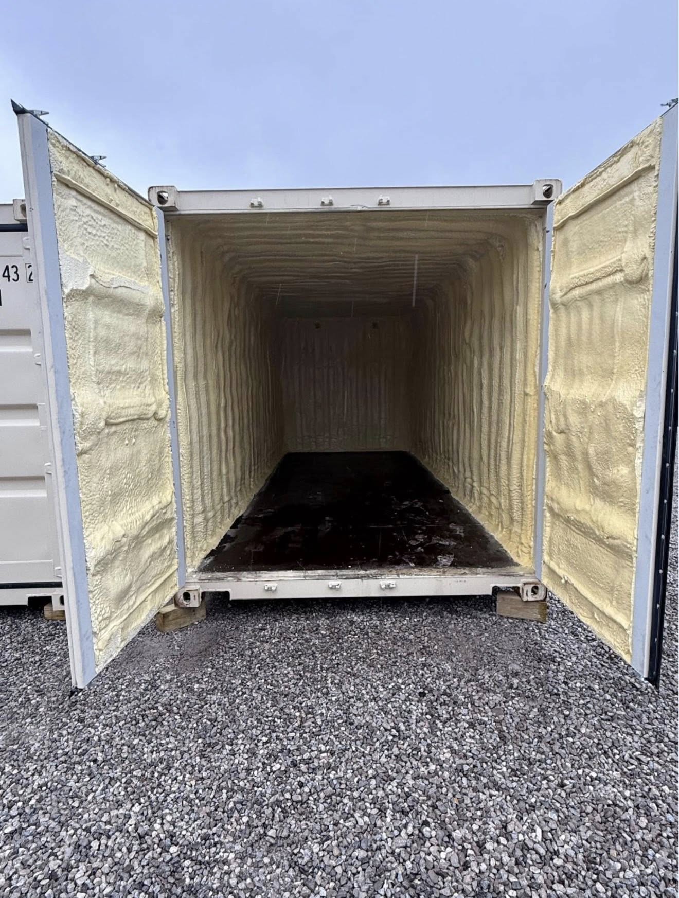 Spray foam replacing fiberglass blankets in a steel building